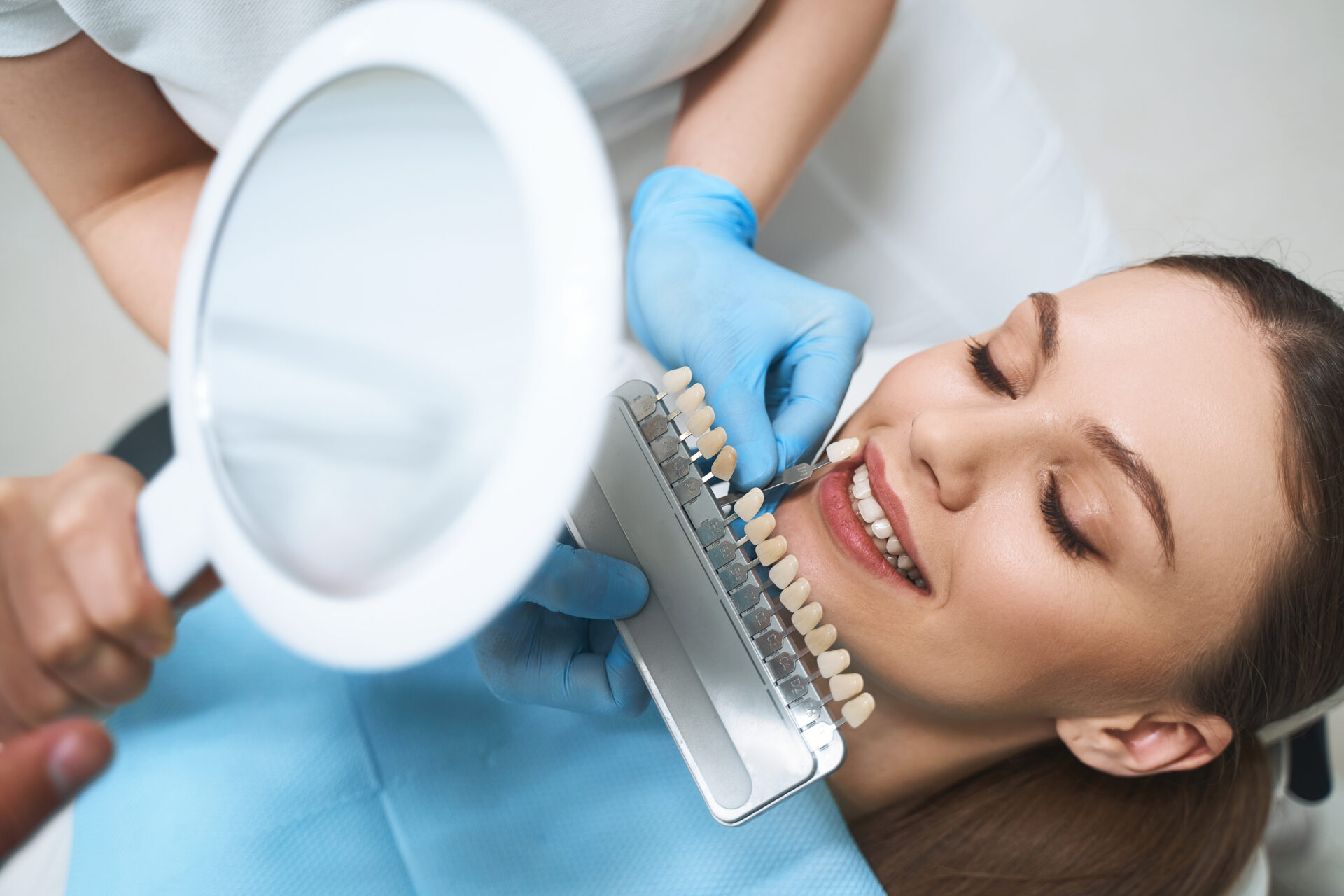 Happy woman taking care of teeth in clinic stock photo veneers