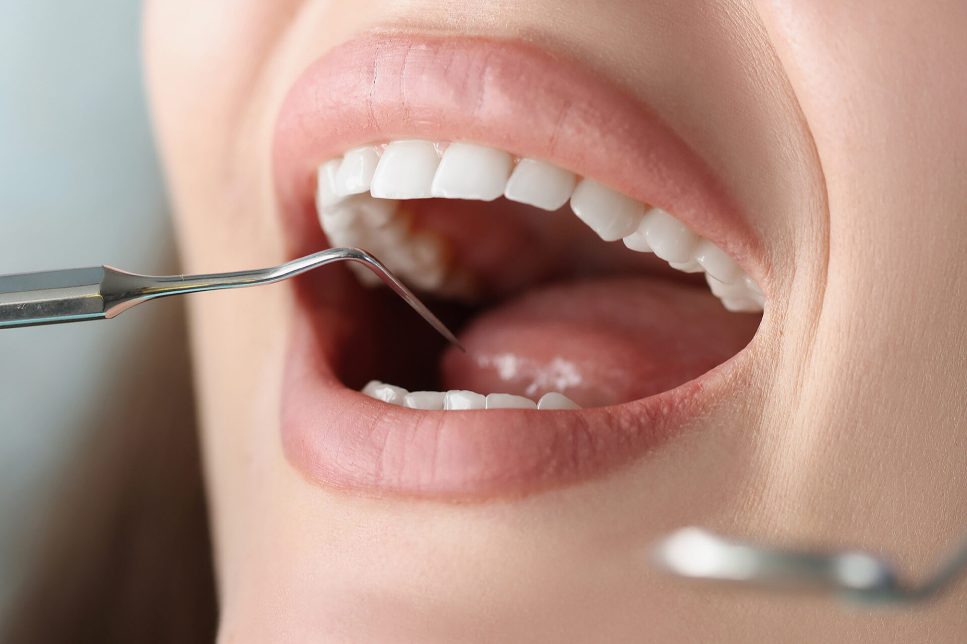 Dentist examines oral cavity of woman patient