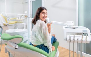 Smiling adult using home teeth whitening kit in Alexandria VA