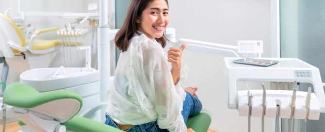 Smiling adult using home teeth whitening kit in Alexandria VA