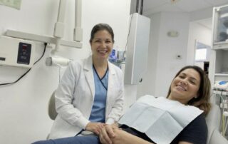 Dentist and patient smile after bonding chipped teeth in Alexandria VA