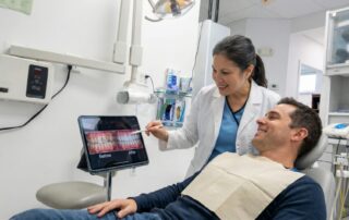 Dentist showing digital smile makeover preview at Woodbridge VA dental clinic