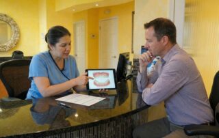 Dentist greeting patient at Dental Clinic in Woodbridge VA, smiling and welcoming