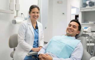 Smiling patient at dentist office in Woodbridge VA learning about porcelain veneers cost breakdown