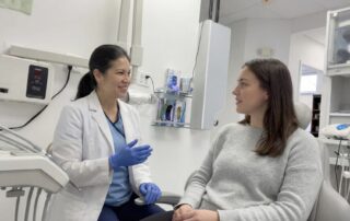 Dentist explaining wisdom teeth extraction process in Woodbridge VA to patient