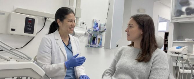 Dentist explaining wisdom teeth extraction process in Woodbridge VA to patient